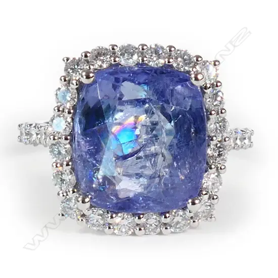 A 14ct white gold tanzanite and diamond halo ring,