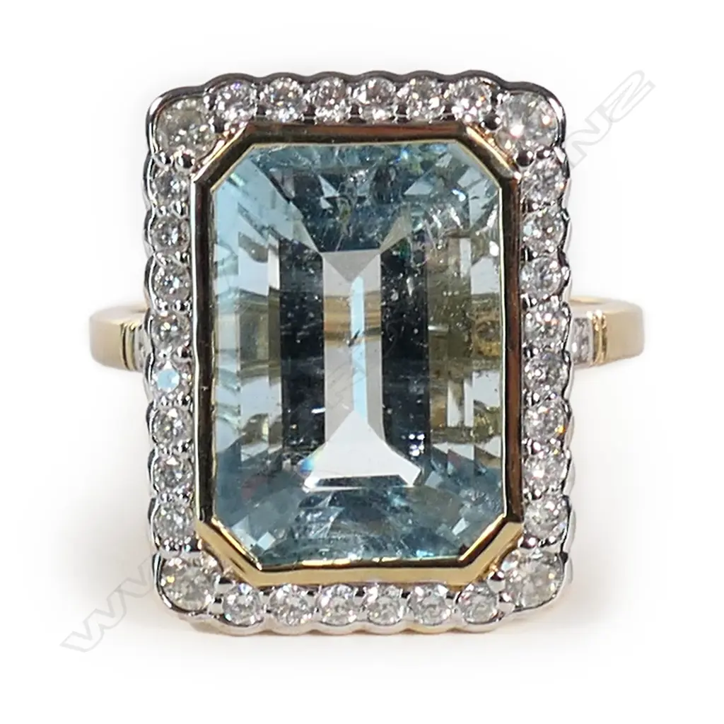A 14ct gold aquamarine and diamond halo ring, Image 1++