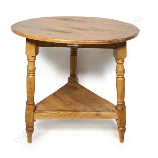 An antique pine cricket table,