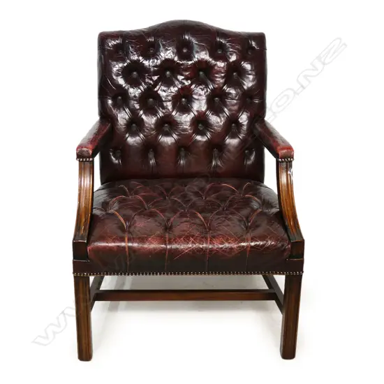 A substantial leather open elbow chair,