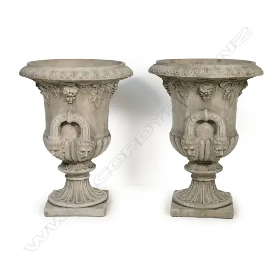 A pair of classical concrete Regency style urns,