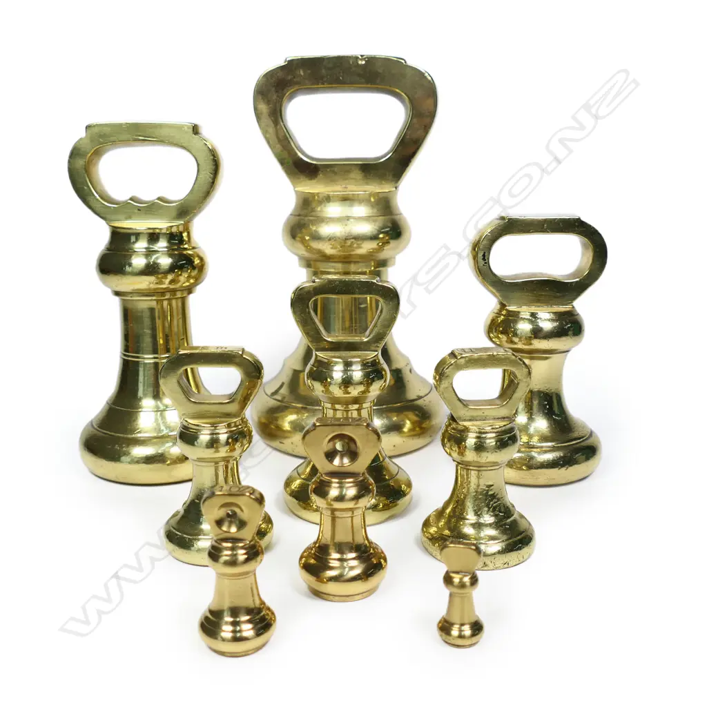 A set of nine graduating brass bell weights, Image 1++