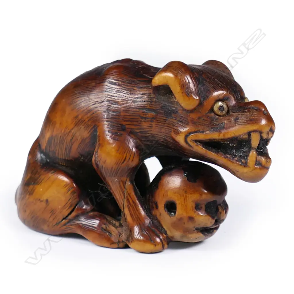An 18thC Edo period carved boxwood wolf netsuke signed Tomotada, Image 1++