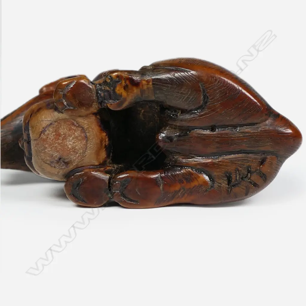 An 18thC Edo period carved boxwood wolf netsuke signed Tomotada, Image 1++