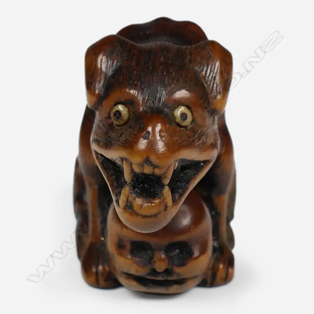 An 18thC Edo period carved boxwood wolf netsuke signed Tomotada, Image 1++
