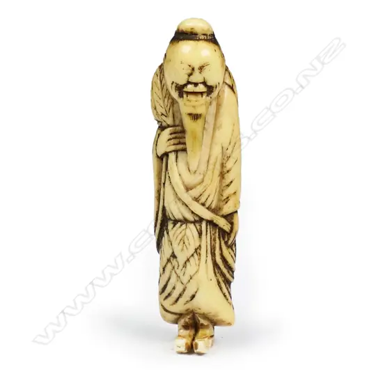 An18thC Edo period carved stag antler netsuke depicting a standing smiling foreigner,
