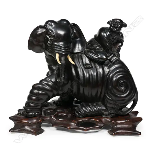 A good old characterfully carved Chinese rosewood model of a seated elephant ,