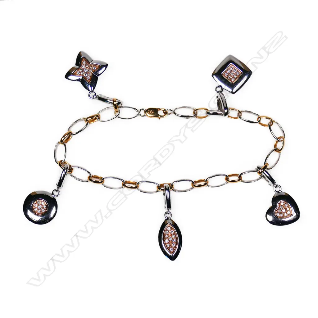 A 9ct and 18ct white and yellow gold diamond set charm type bracelet, Image 1++