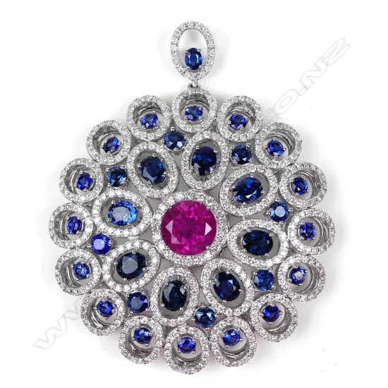 A large and impressive 18ct. white gold sapphire and diamond disc form pendant,