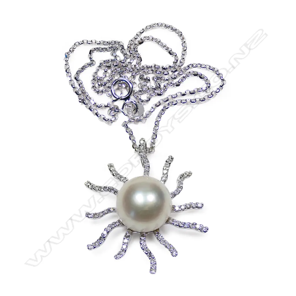 An 18ct white gold diamond and pearl set sun burst pendant necklace, Image 1++