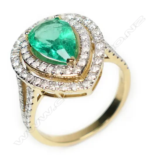14ct gold Columbian emerald and diamond double halo ring,