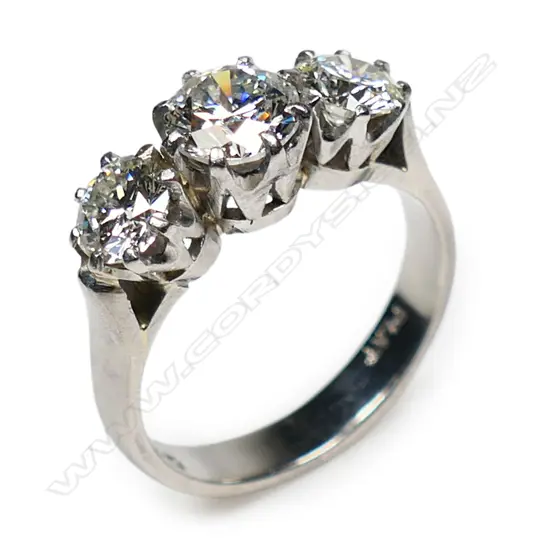 A platinum and three stone diamond ring,