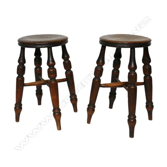 A pair of antique fruitwood country stools,