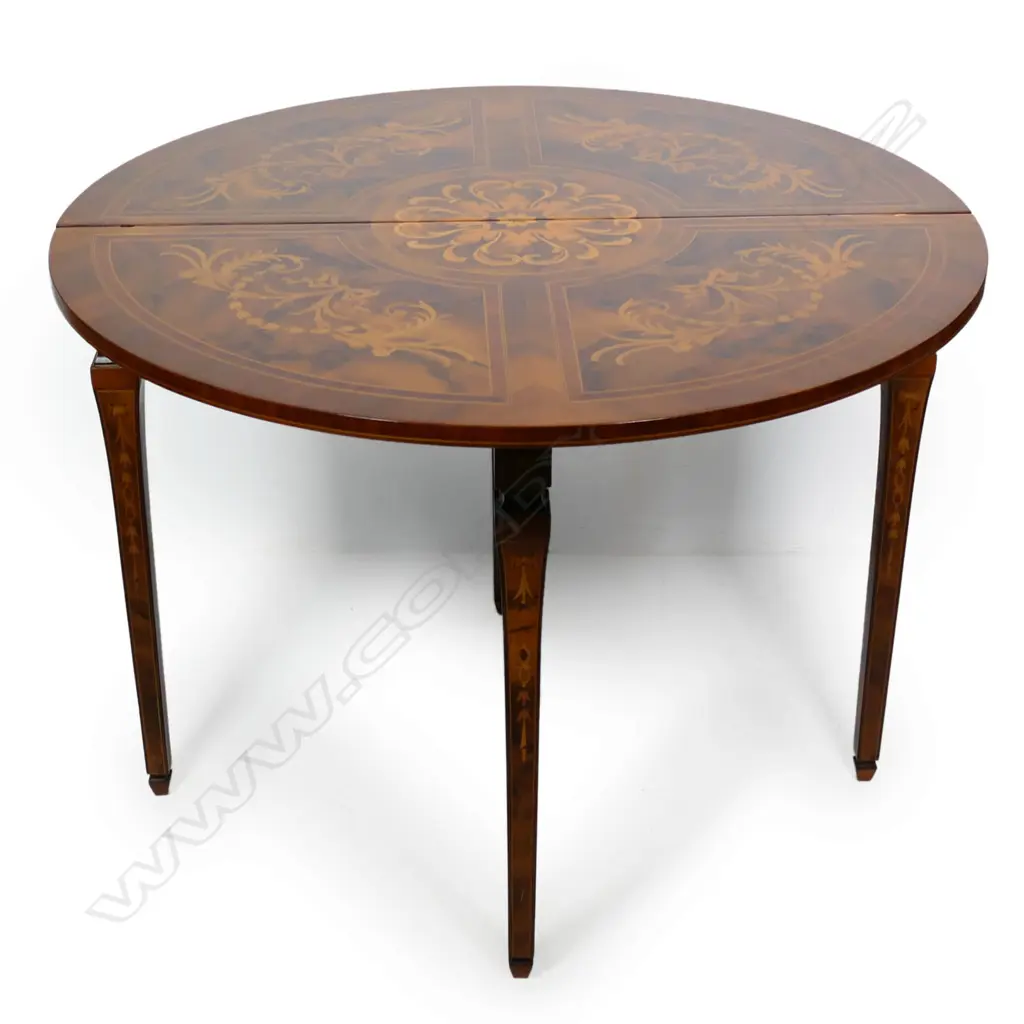 An Italian round marquetry fold over table, Image 1++