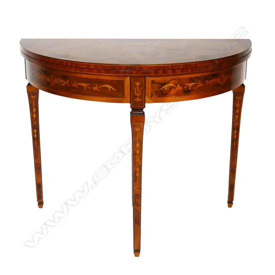 An Italian round marquetry fold over table,