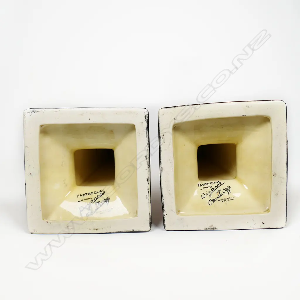 A pair of Clarice Cliff Bizarre orange 'Trees and House' candlesticks, Image 1++