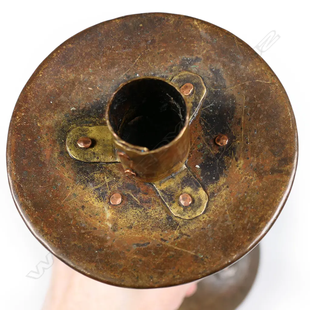 An Arts and Crafts hammered copper candlestick by Arthur John Seward, Image 1++