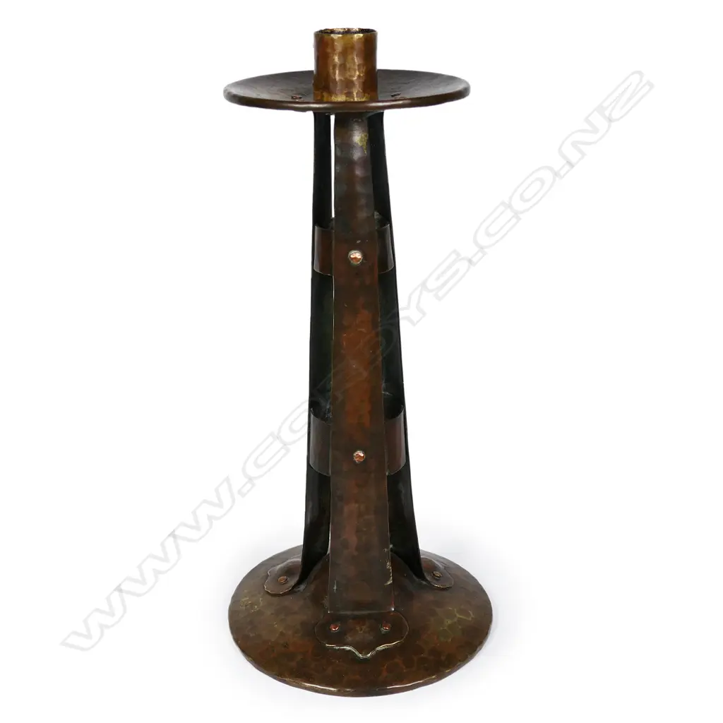 An Arts and Crafts hammered copper candlestick by Arthur John Seward, Image 1++