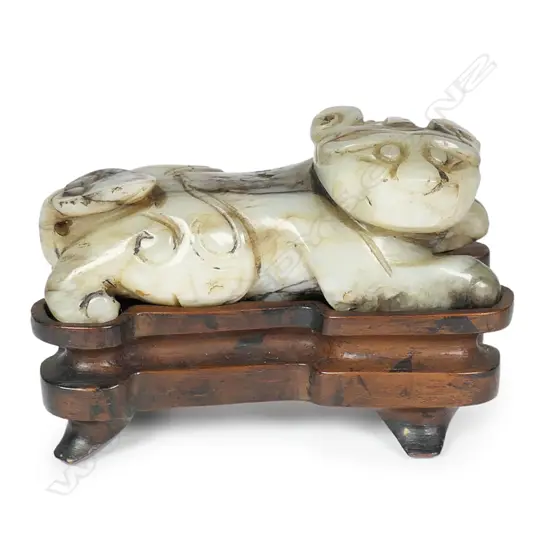 An old Chinese striated pale green jade carving of a Bixie,