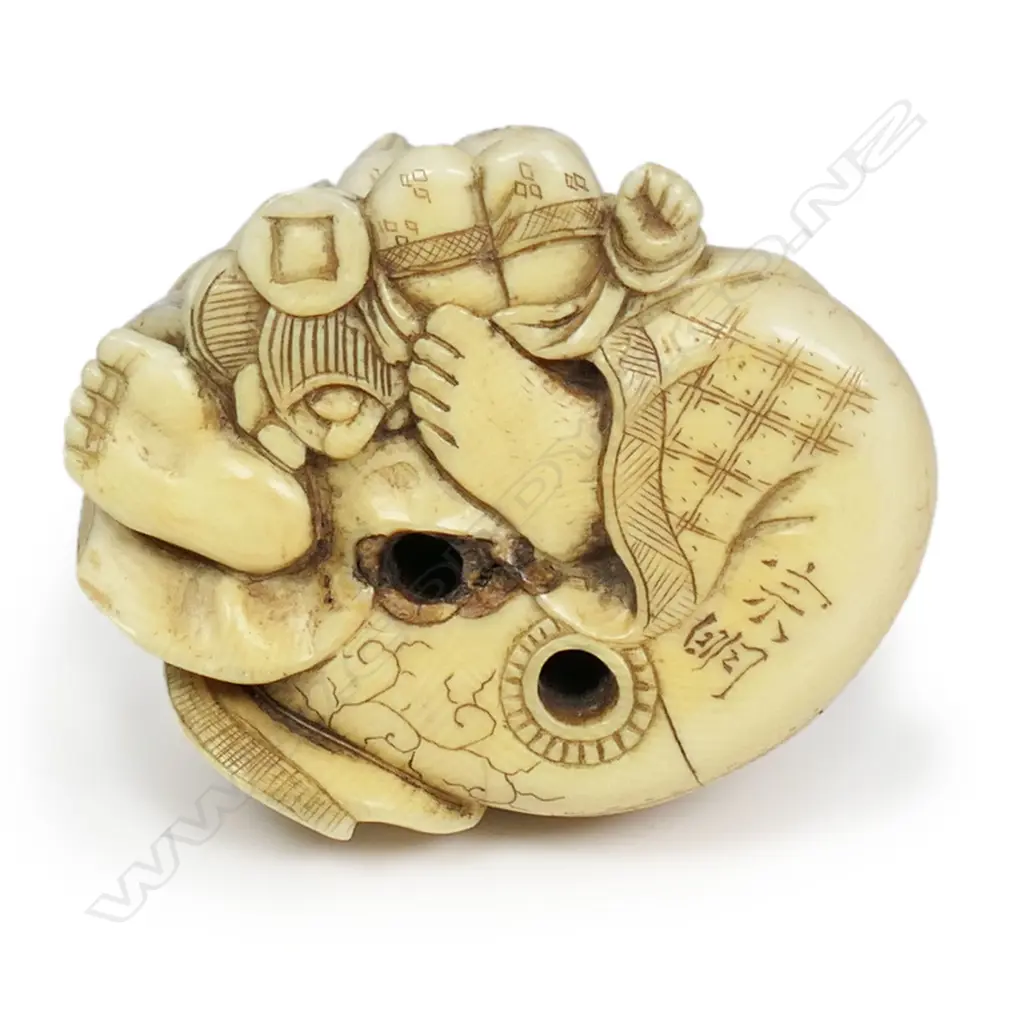 A Meiji Japanese carved ivory okimono of a gent with two young children, finely detailed and stained. Signed to the base. H.45mm. Provenance: From the collection of Gerry and Valerie Bermel (of Travis Antiques. Wellington 1950's to 1986). Image 1++