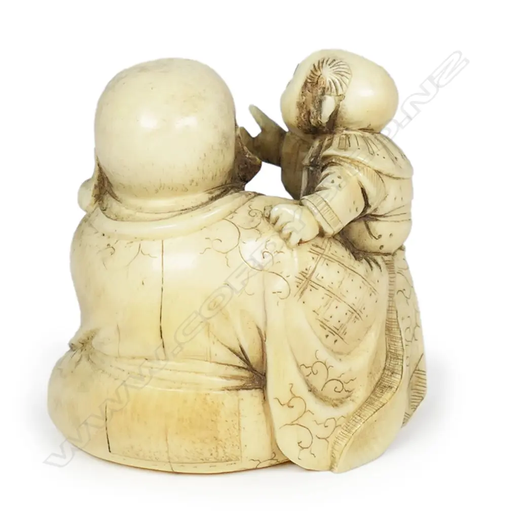 A Meiji Japanese carved ivory okimono of a gent with two young children, finely detailed and stained. Signed to the base. H.45mm. Provenance: From the collection of Gerry and Valerie Bermel (of Travis Antiques. Wellington 1950's to 1986). Image 1++