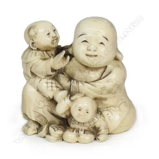 A Meiji Japanese carved ivory okimono of a gent with two young children, finely detailed and stained. Signed to the base. H.45mm. Provenance: From the collection of Gerry and Valerie Bermel (of Travis Antiques. Wellington 1950's to 1986).