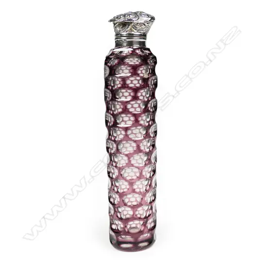 An Edwardian silver topped mauve flashed cut glass scent bottle,