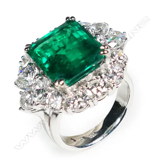 An impressive 18ct white gold emerald and diamond dress ring,