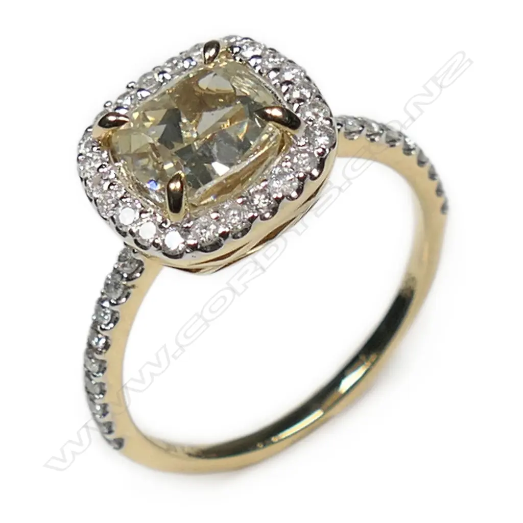 A 14ct gold fancy yellow diamond halo ring, Image 1++