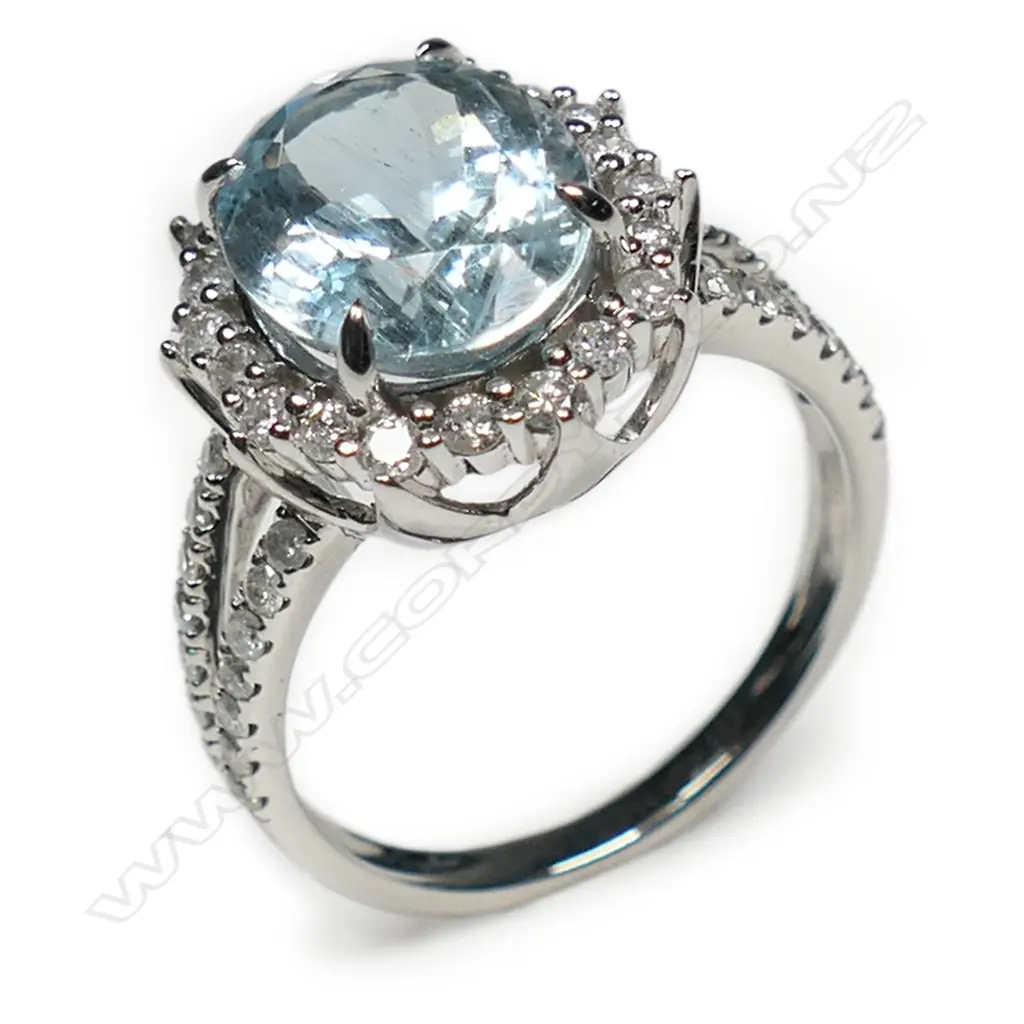 A 14ct white gold aquamarine and diamond halo split band ring, Image 1++
