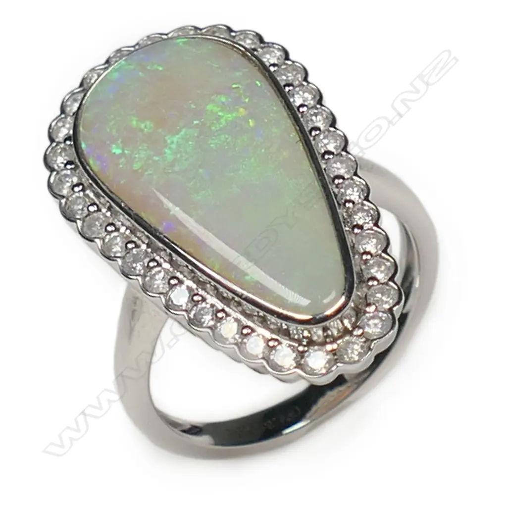 A 14ct white gold opal and diamond halo ring, Image 1++