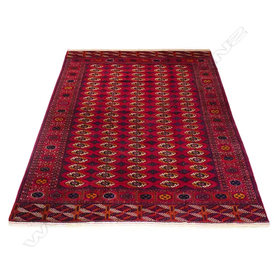 A fine old hand-knotted Persian Bukhara carpet,