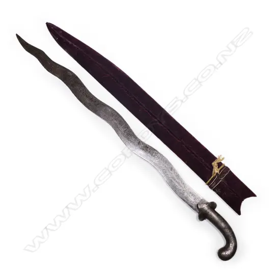 A Northern Indian sword with wavy blade, silver inlaid handle,