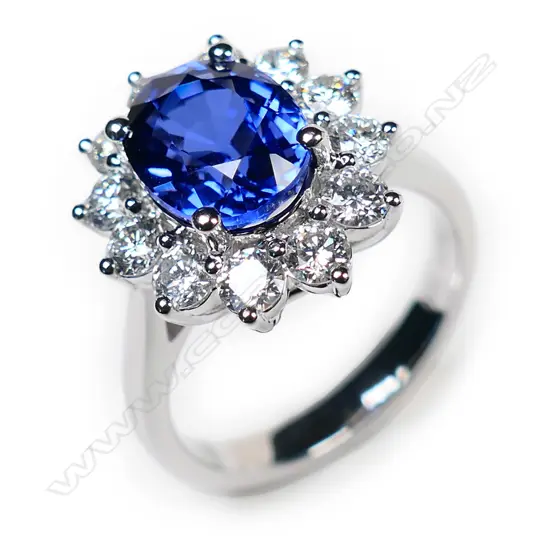 A good 18ct white gold synthetic sapphire and diamond cluster Princess Diana ring,