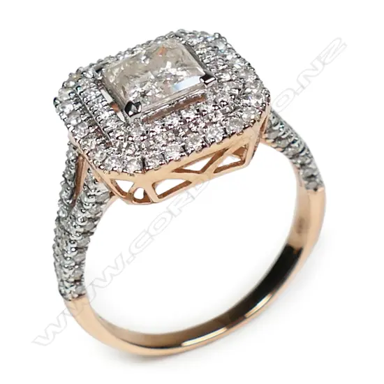 A 14ct rose and white gold diamond double halo ring,
