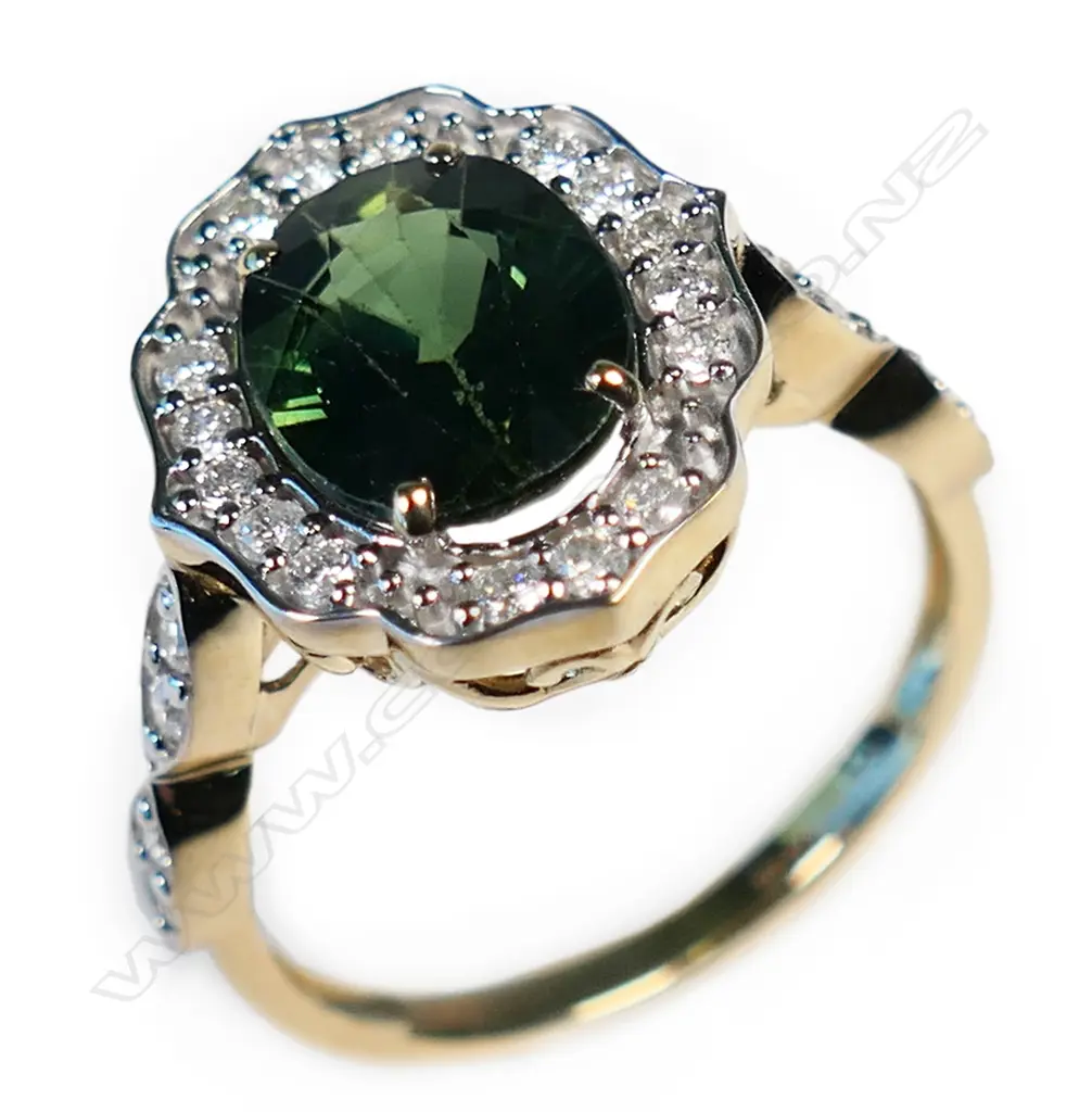 A 14ct gold green sapphire and diamond halo ring, Image 1++