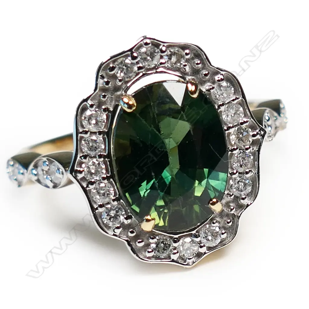 A 14ct gold green sapphire and diamond halo ring, Image 1++