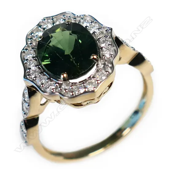 A 14ct gold green sapphire and diamond halo ring,