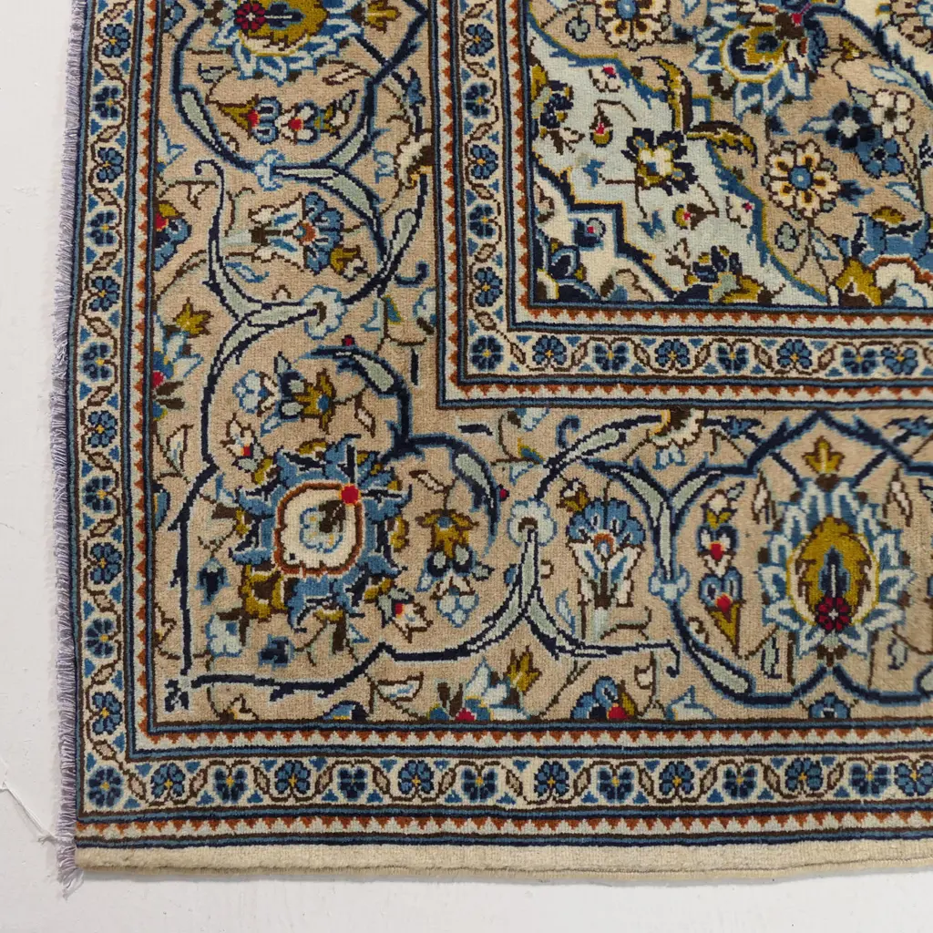 A quality hand-knotted Kashan carpet, the field decorated with a central medallion surrounded by flowing tendrils and conforming small medallions on an ivory ground, deep cream quadrants, multiple border guards. Image 1++