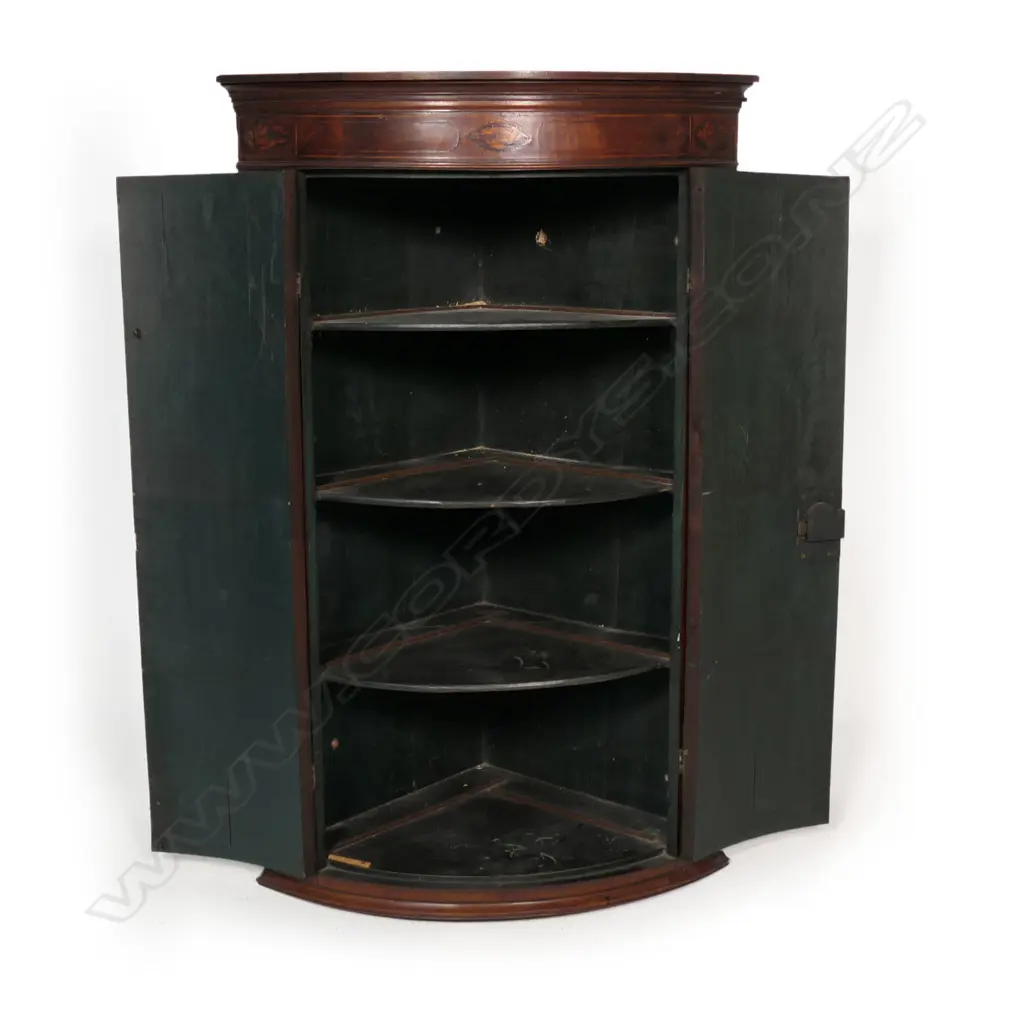 A Georgian mahogany Sheraton style corner cabinet, inlaid stringing, to doors and pediment with shell detail, three shelves to the painted interior. 800 x 460 x 1100mm. Image 1++