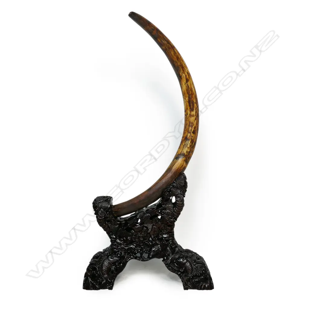 An ancient full woolly mammoth tusk on carved stand, Image 1++