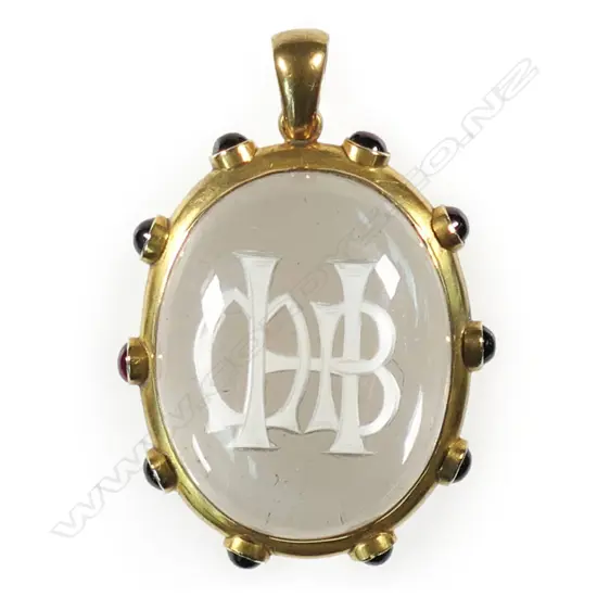 A Victorian gold and garnet framed rock crystal pendant,