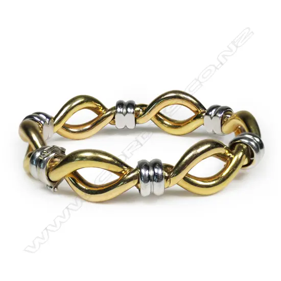 An 18ct white and yellow gold bangle,