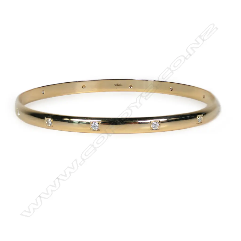 A modern 9ct yellow gold and diamond set bangle, Image 1++