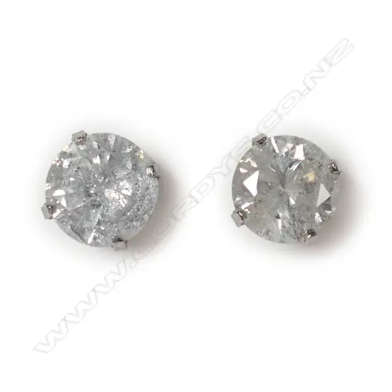 A pair of 14ct white gold and diamond stud earrings,