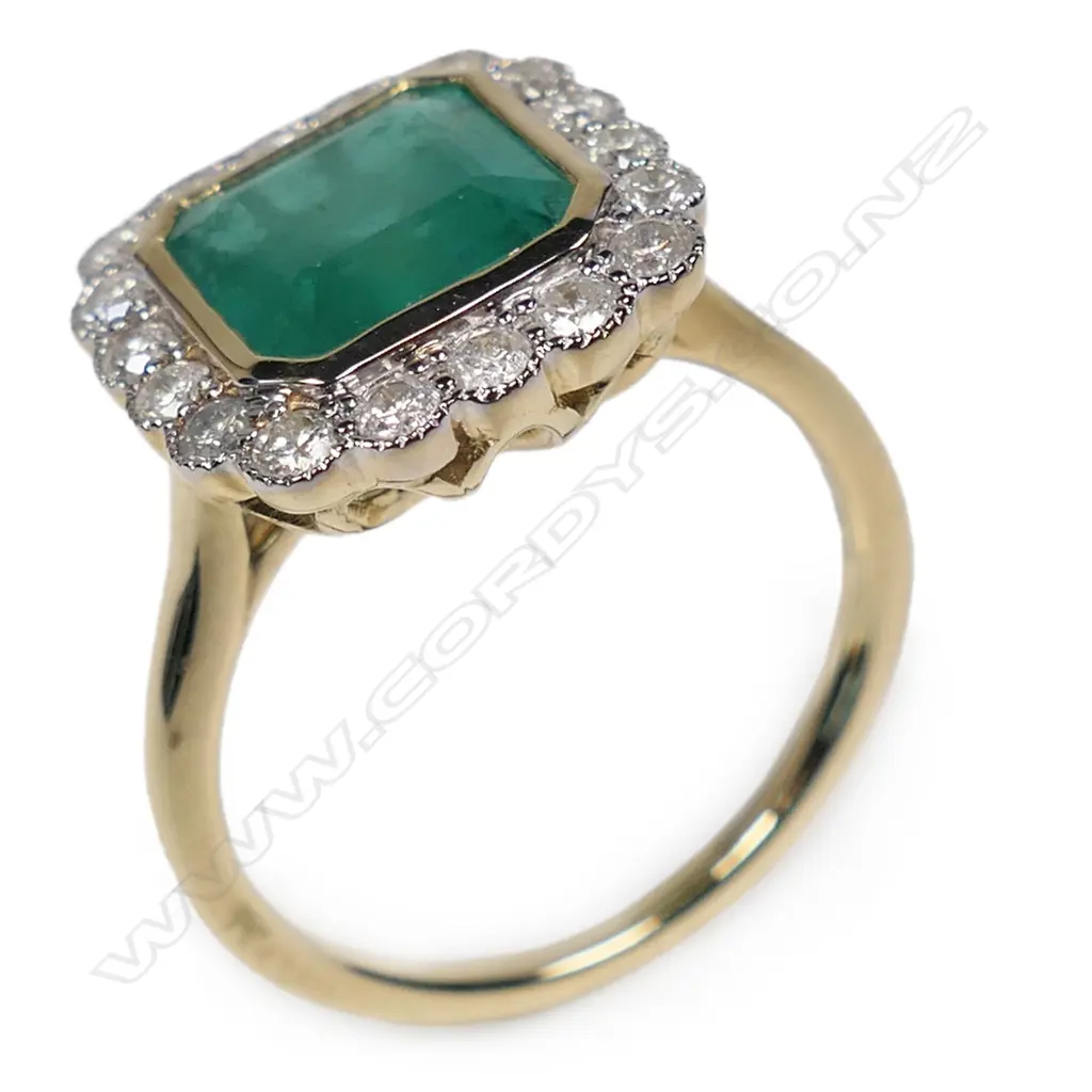 A 14ct gold emerald and diamond halo ring, Image 1++