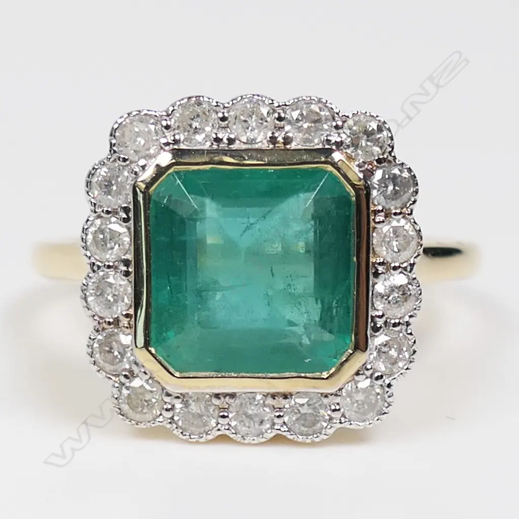 A 14ct gold emerald and diamond halo ring, Image 1++