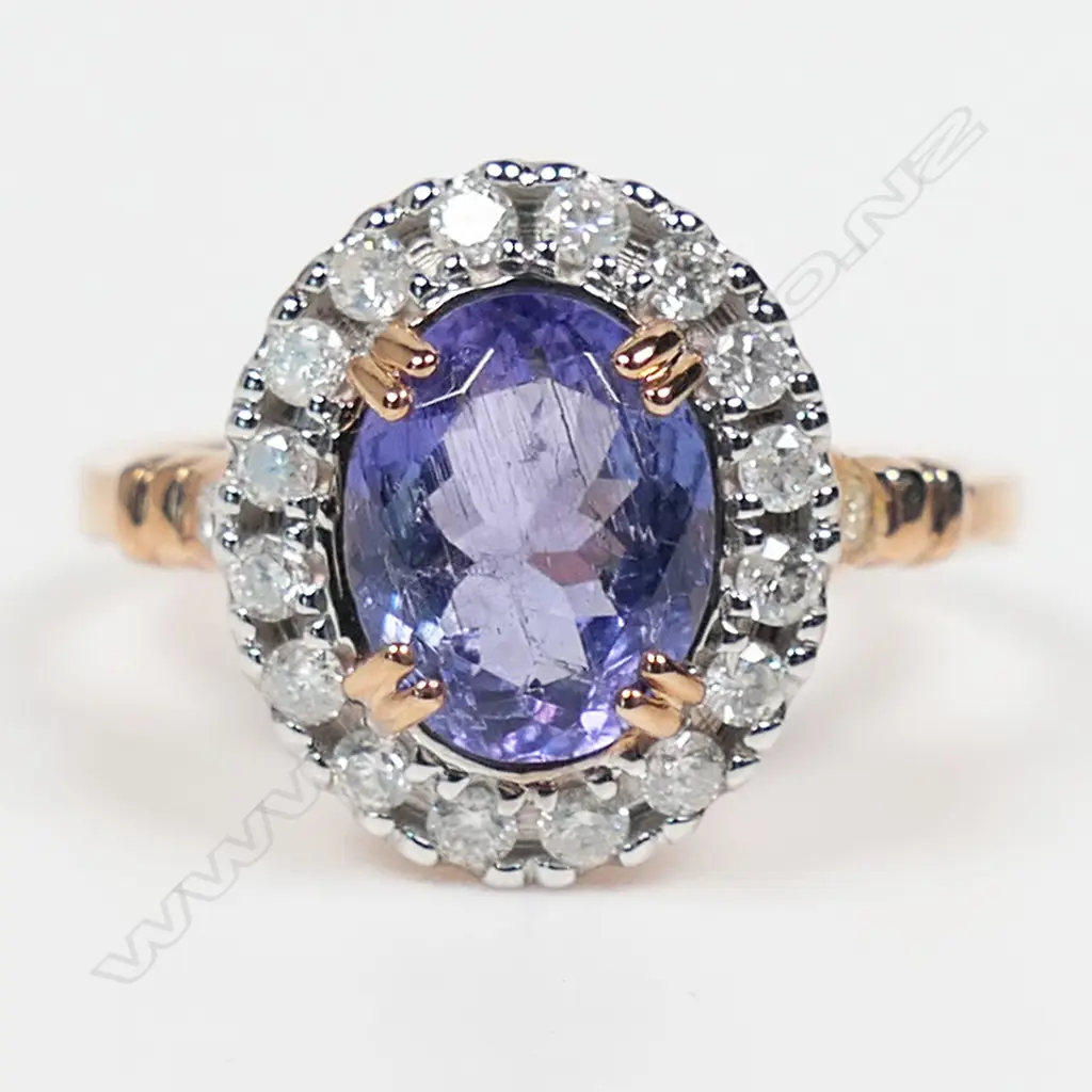 A 14ct rose gold tanzanite and diamond halo ring, Image 1++