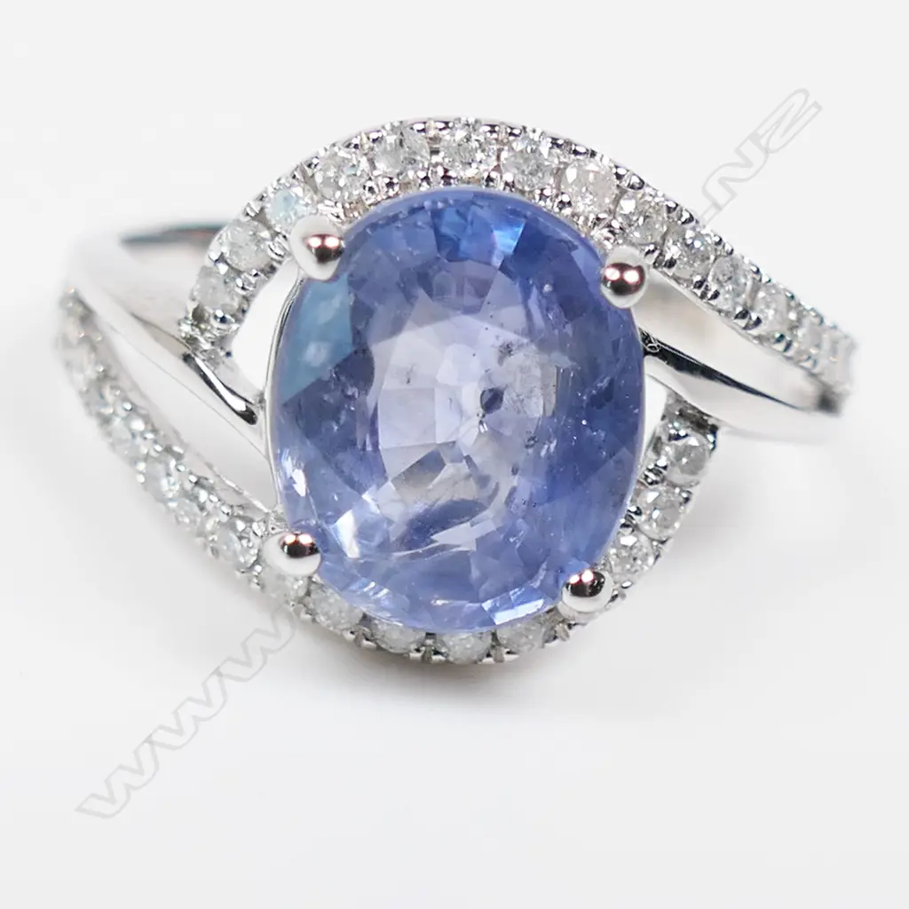 A 14ct white gold sapphire and diamond crossover style ring, Image 1++