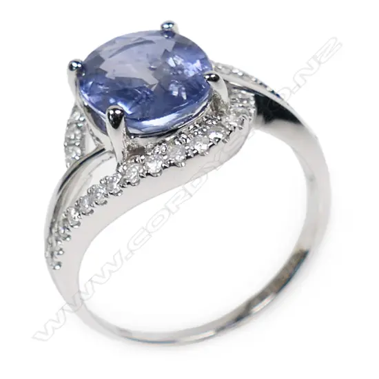 A 14ct white gold sapphire and diamond crossover style ring,